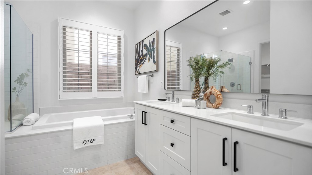 138 Jayhawk Irvine, CA 92602 - Photo 19 of 50 a bathroom with a granite countertop sink mirror and a bathtub