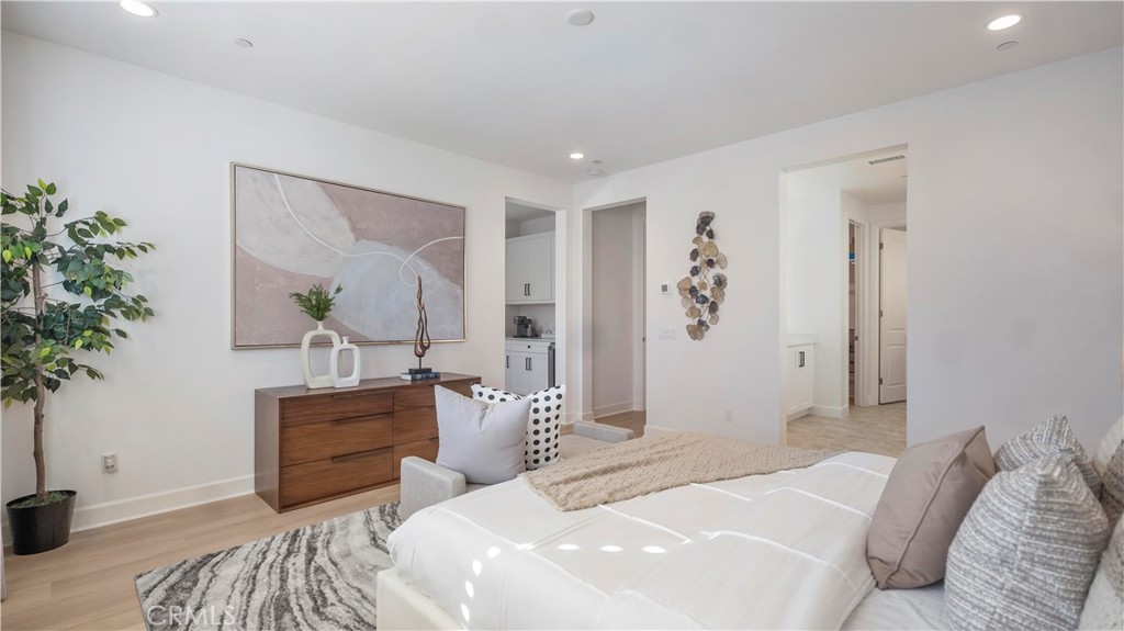 138 Jayhawk Irvine, CA 92602 - Photo 29 of 50 a bedroom with a large bed and a potted plant