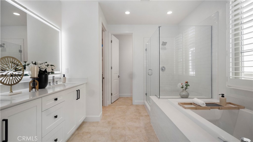 138 Jayhawk Irvine, CA 92602 - Photo 32 of 50 a bathroom with a tub sink and mirror