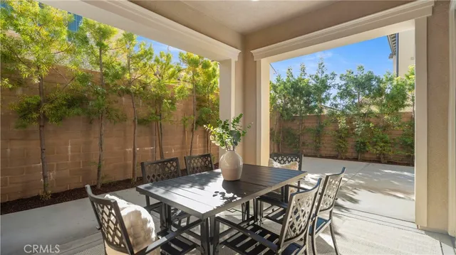 a view of a patio with table and chairs and potted plants