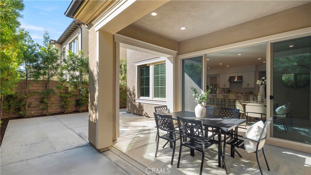 138 Jayhawk Irvine, CA 92602 - Photo 45 of 50 a view of a patio with table and chairs and potted plants