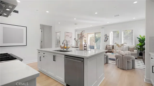 a kitchen with kitchen island a stove a table and chairs in it