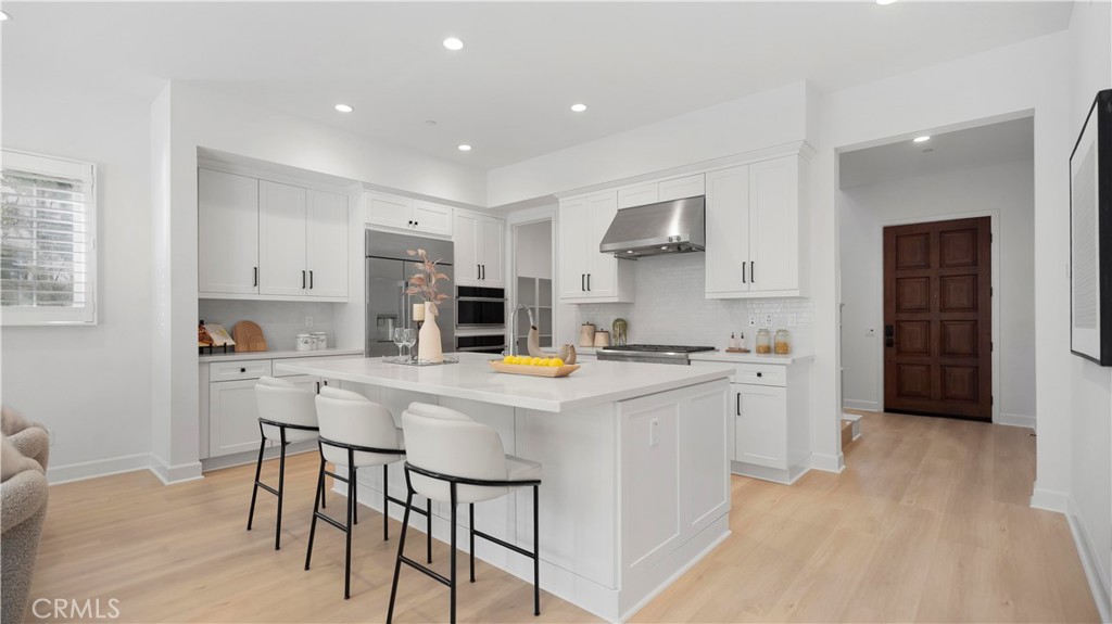 138 Jayhawk Irvine, CA 92602 - Photo 9 of 50 a kitchen with kitchen island a stove a table and chairs in it