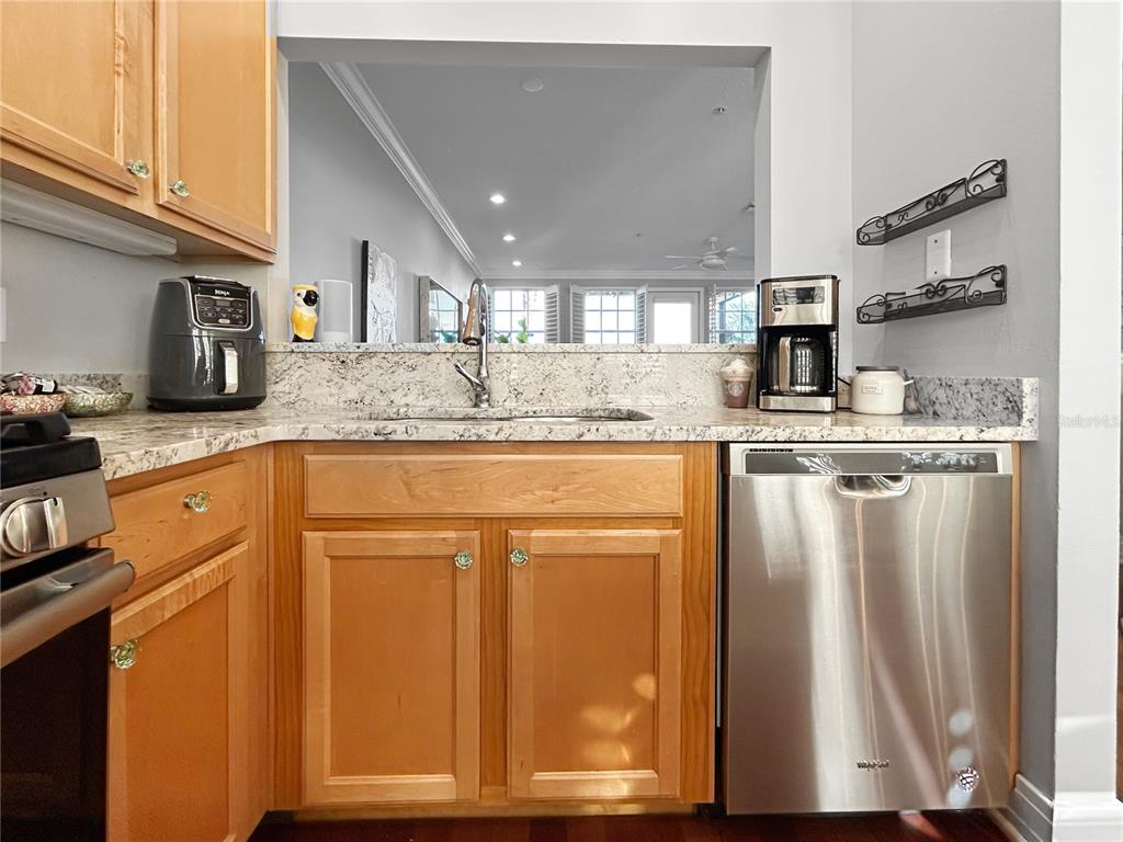1468 Harbour Walk Road Tampa, FL 33602 - Photo 12 of 40 a kitchen with kitchen island granite countertop a sink cabinets and stainless steel appliances