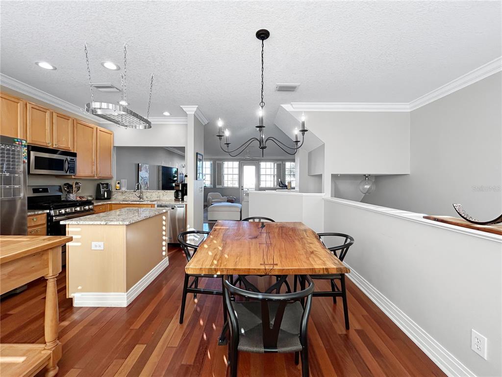 1468 Harbour Walk Road Tampa, FL 33602 - Photo 14 of 40 a kitchen with stainless steel appliances wooden floors dining table and chairs