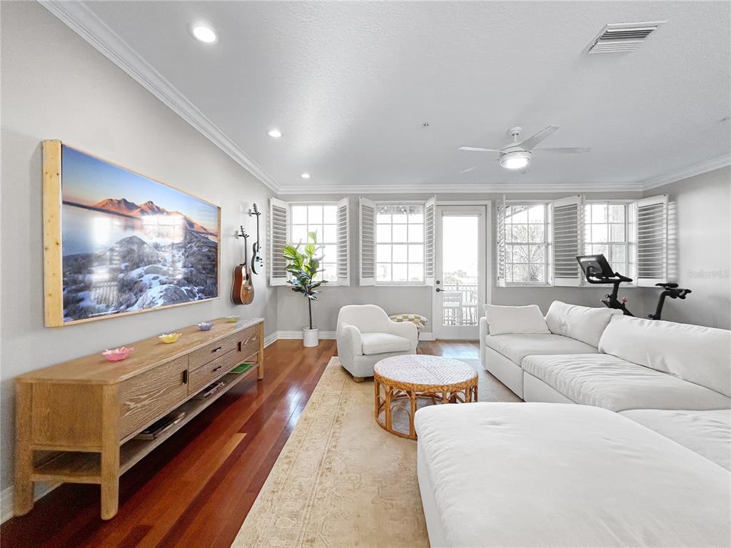 1468 Harbour Walk Road Tampa, FL 33602 - Photo 3 of 40 a living room with furniture a flat screen tv and a floor to ceiling window