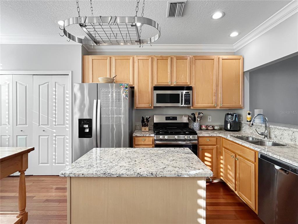 1468 Harbour Walk Road Tampa, FL 33602 - Photo 10 of 40 a kitchen with stainless steel appliances granite countertop a sink dishwasher stove top oven and microwave with wooden floor