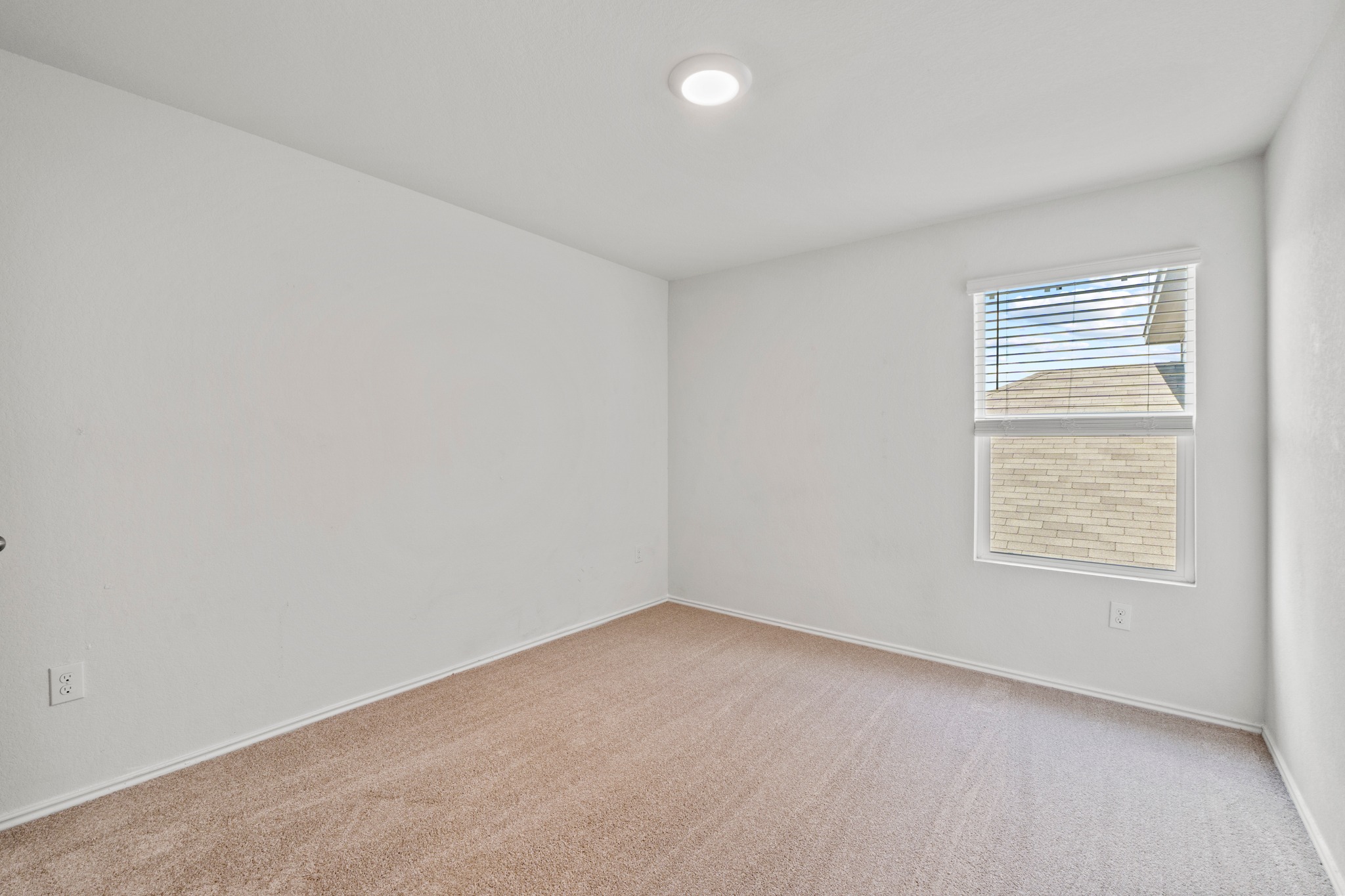 14917 Bajada Rd Manor Manor, TX 78653 - Photo 23 of 31 Neutral toned carpeting with white baseboards and walls