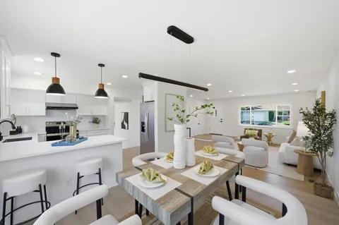 a living room with furniture and kitchen view