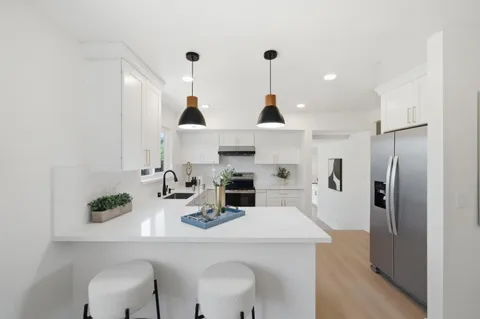 a kitchen with refrigerator a sink and cabinets