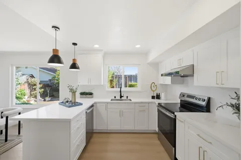 a kitchen with a sink stove and cabinets