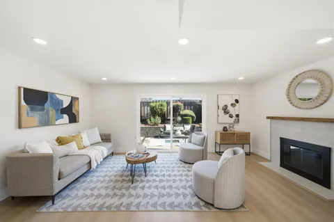 a living room with furniture a rug and a fireplace