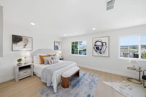 a bedroom with a bed and a couch