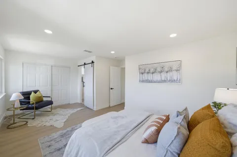 a bedroom with a bed and chair