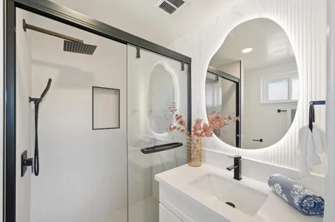 a bathroom with double vanity sink and a mirror