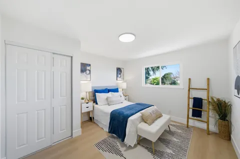 a bedroom with a bed and a couch