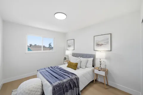 a bedroom with a bed and a lamp