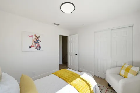 a bedroom with a bed and a couch