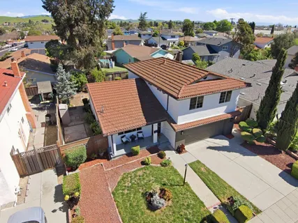 an aerial view of a house with a yard patio and lake view