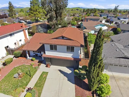 an aerial view of a house with garden space and street view