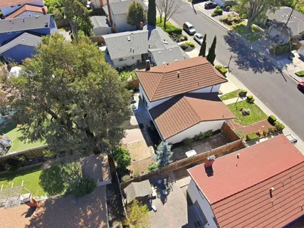 an aerial view of a house with outdoor space