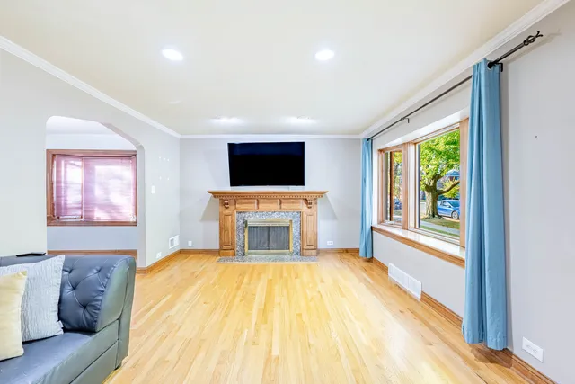 a view of a livingroom with furniture a flat screen tv and staircase