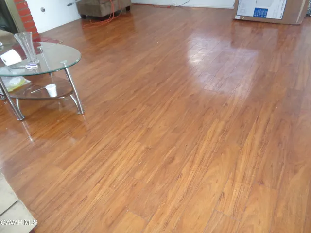 a view of a room with wooden floor