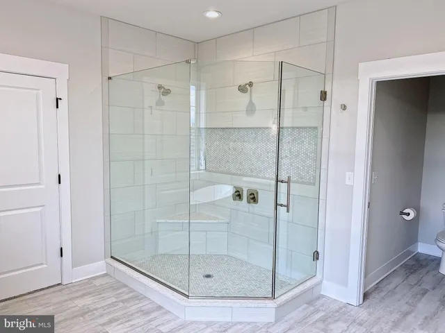 a bathroom with a shower and a sink