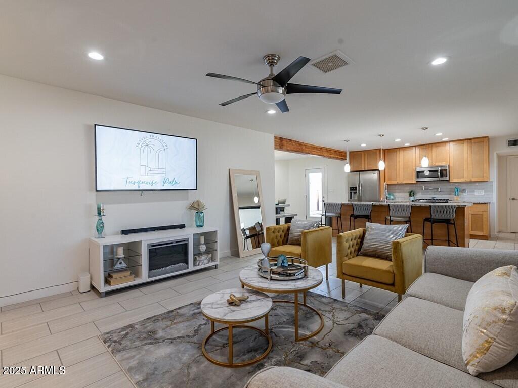 3302 East Turquoise Avenue Phoenix, AZ 85028 - Photo 12 of 59 a living room with furniture and a fireplace