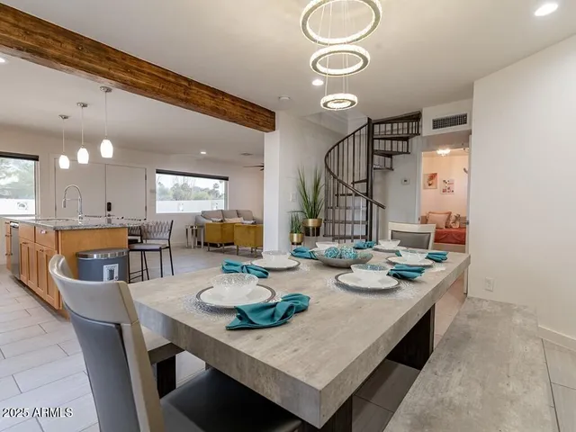 a kitchen with stainless steel appliances granite countertop a kitchen island a stove a sink a refrigerator a microwave oven with cabinets and wooden floor