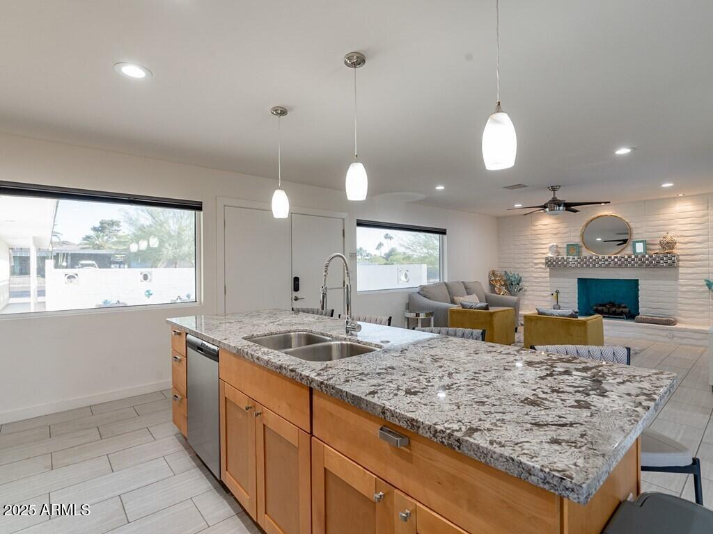 3302 East Turquoise Avenue Phoenix, AZ 85028 - Photo 18 of 59 a kitchen with kitchen island granite countertop wooden cabinets a oven and a sink