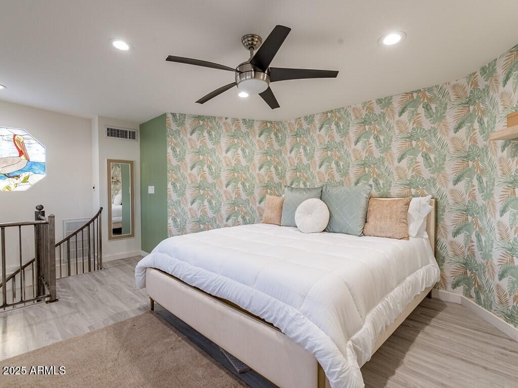 3302 East Turquoise Avenue Phoenix, AZ 85028 - Photo 21 of 59 a bedroom with a large bed and a chandelier