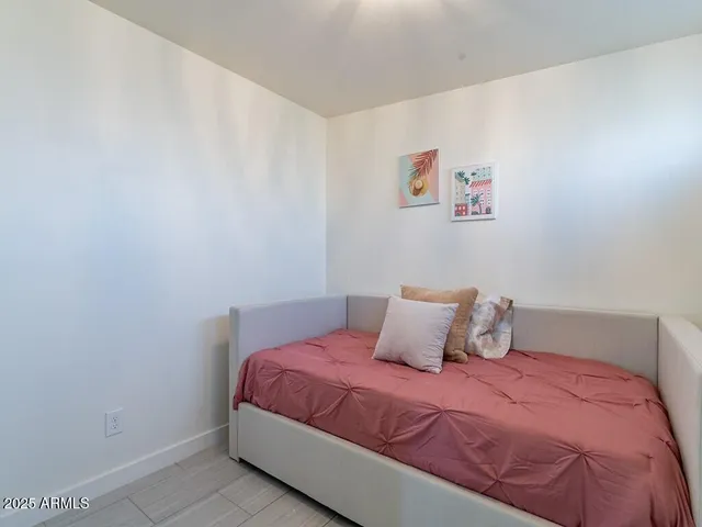 a bedroom with a large bed and a tv