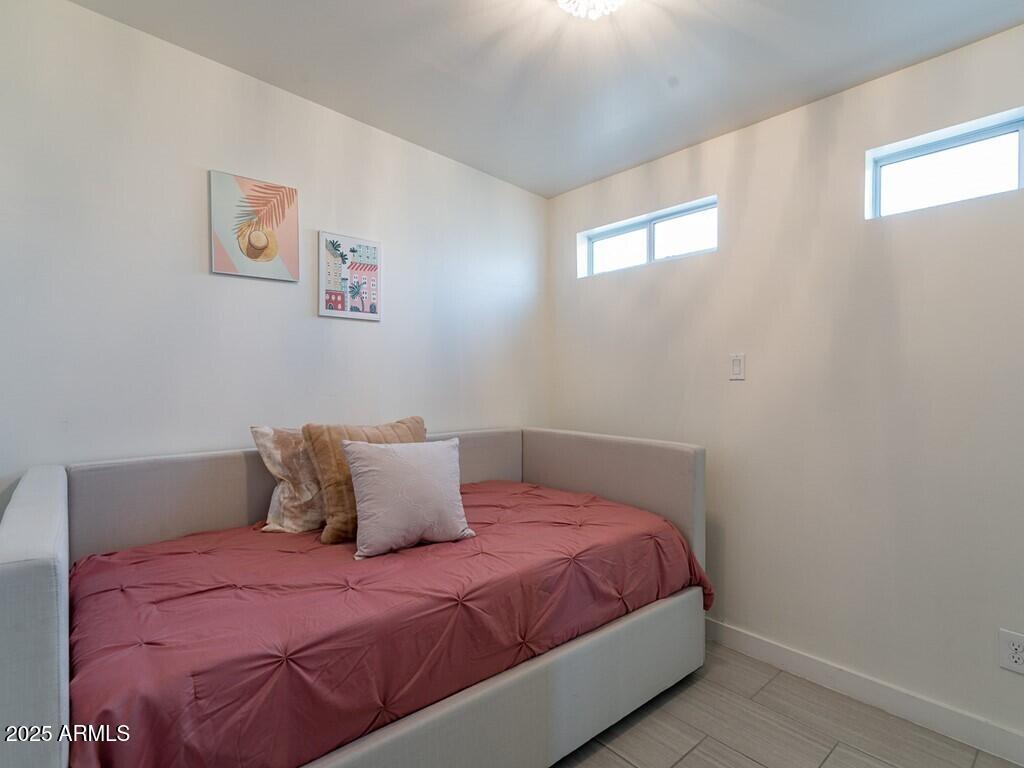 3302 East Turquoise Avenue Phoenix, AZ 85028 - Photo 24 of 59 a bedroom with a bed and a window