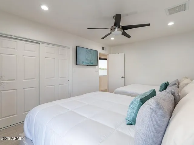 a bedroom with a bed and a chandelier