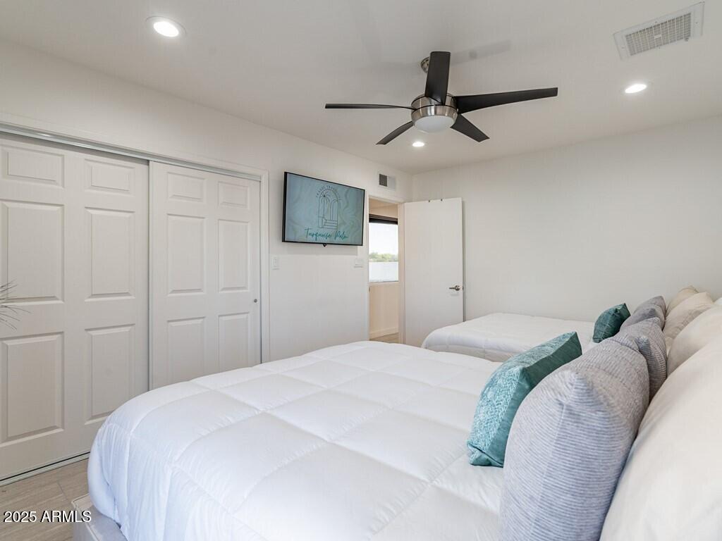 3302 East Turquoise Avenue Phoenix, AZ 85028 - Photo 27 of 59 a bedroom with a large bed and a tv