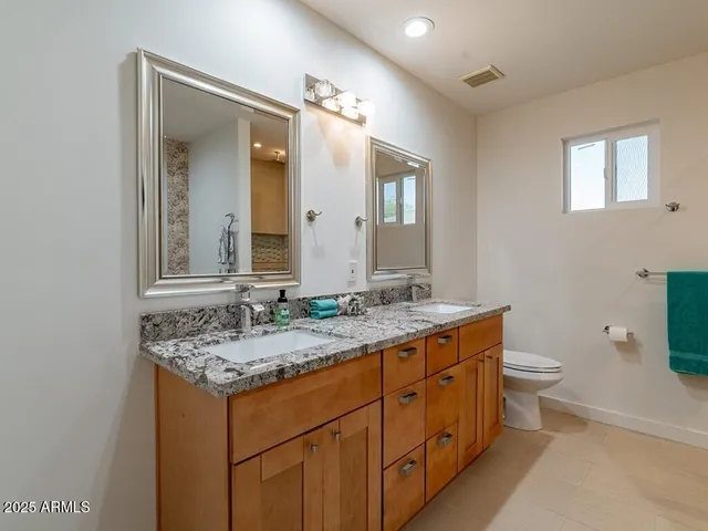 a bedroom with a bed and a ceiling fan