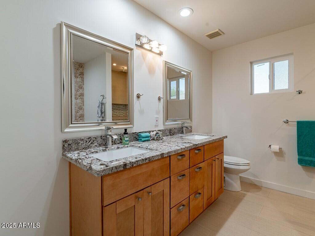 3302 East Turquoise Avenue Phoenix, AZ 85028 - Photo 28 of 59 a bathroom with a granite countertop sink and a mirror