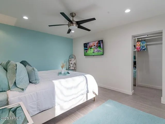 a bathroom with a granite countertop sink a mirror and shower