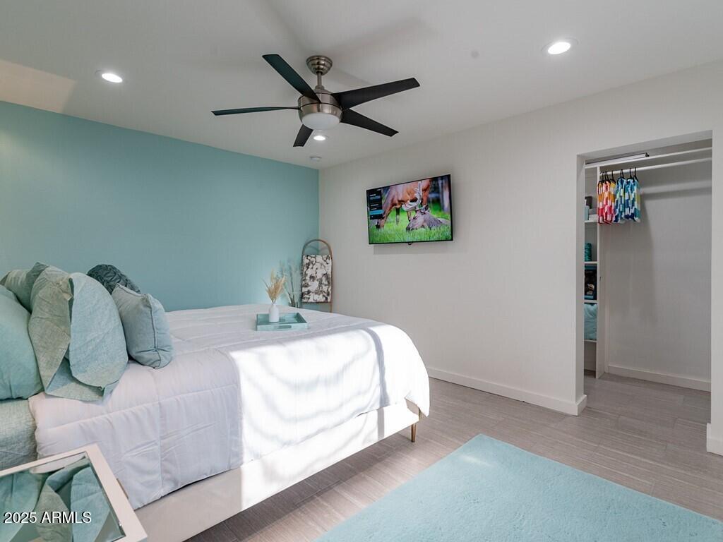 3302 East Turquoise Avenue Phoenix, AZ 85028 - Photo 31 of 59 a bedroom with a bed and a chandelier