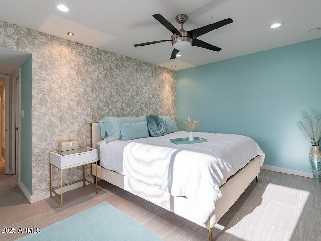 3302 East Turquoise Avenue Phoenix, AZ 85028 - Photo 32 of 59 a bedroom with a bed and a ceiling fan