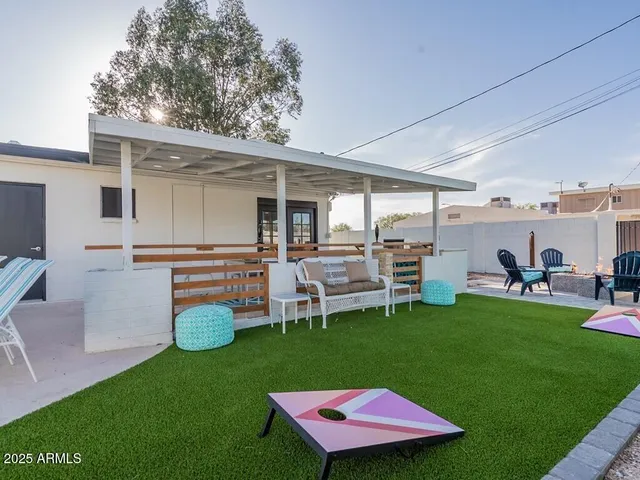 a patio with a table and chairs