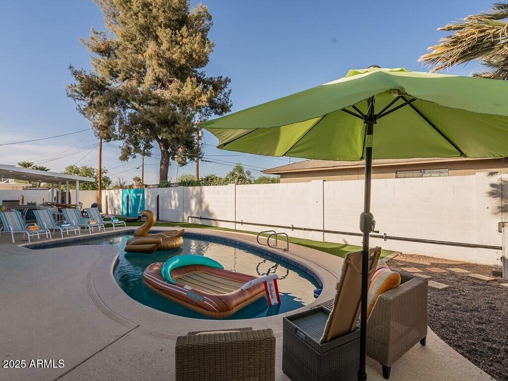 3302 East Turquoise Avenue Phoenix, AZ 85028 - Photo 46 of 59 a view of swimming pool with outdoor seating and plants