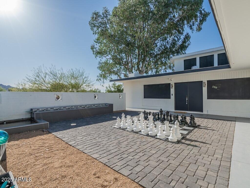 3302 East Turquoise Avenue Phoenix, AZ 85028 - Photo 6 of 59 a view of a patio with table and chairs and potted plants