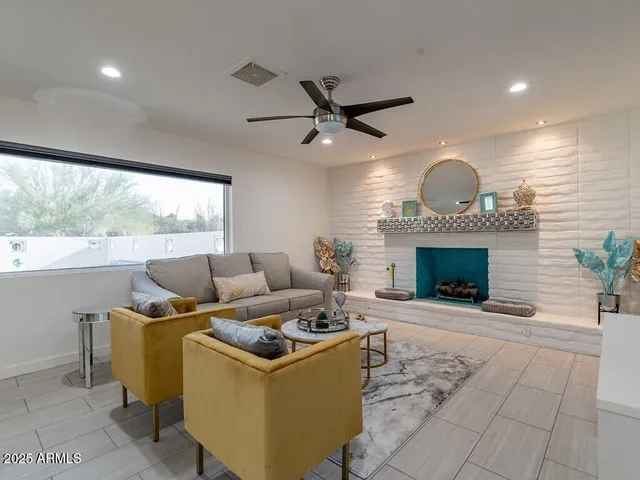 a living room with furniture and a fireplace