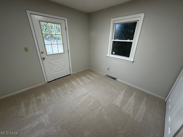 586 Ingalls Road Akron, OH 44312 - Photo 11 of 21 Doorway to outside with carpet flooring and baseboards