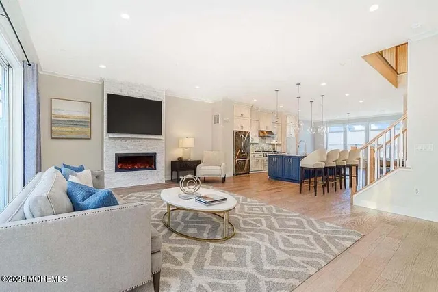 a living room with furniture a fireplace and a flat screen tv