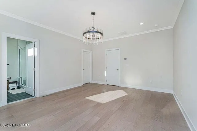 a view of an empty room with a chandelier