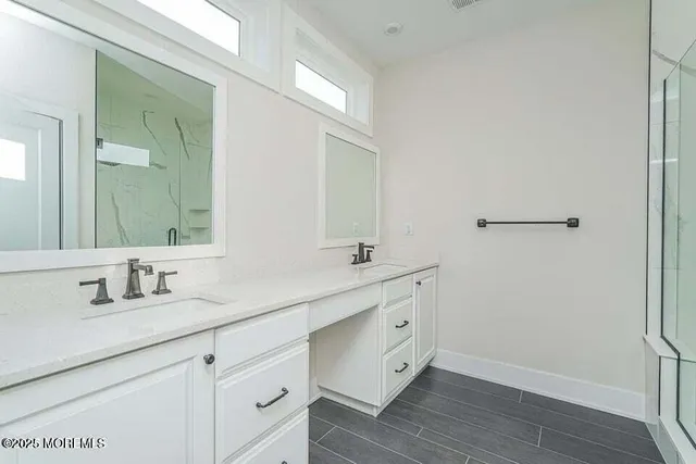 a bathroom with a double vanity sink and mirror
