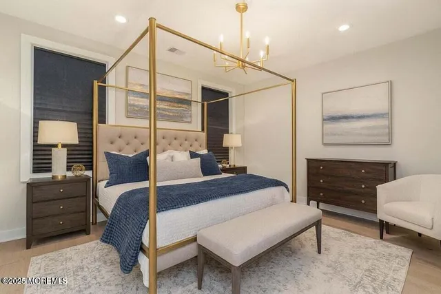 a bedroom with a bed a table and chair